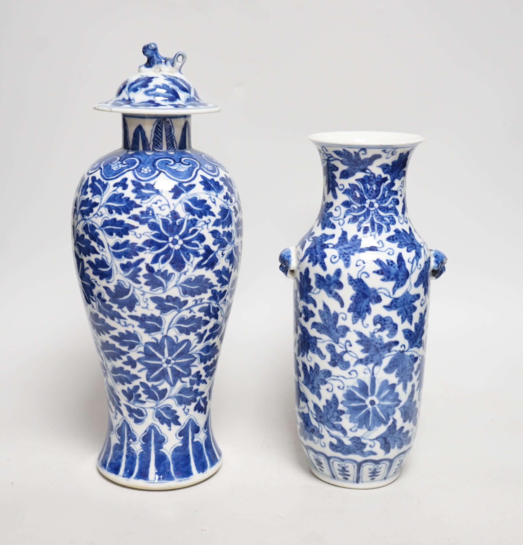 A late 19th century Chinese blue and white 'Lotus' vase and cover and another similar (2), tallest 31cm